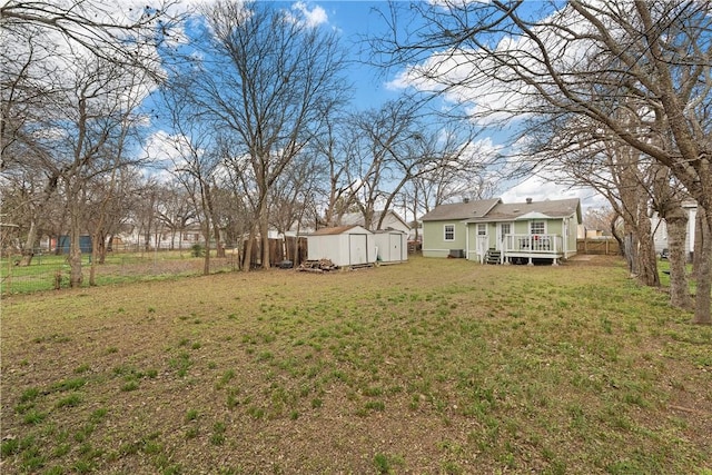 view of yard featuring a storage shed and a deck