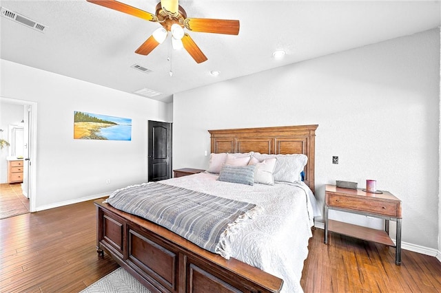 bedroom with ceiling fan and dark wood-type flooring