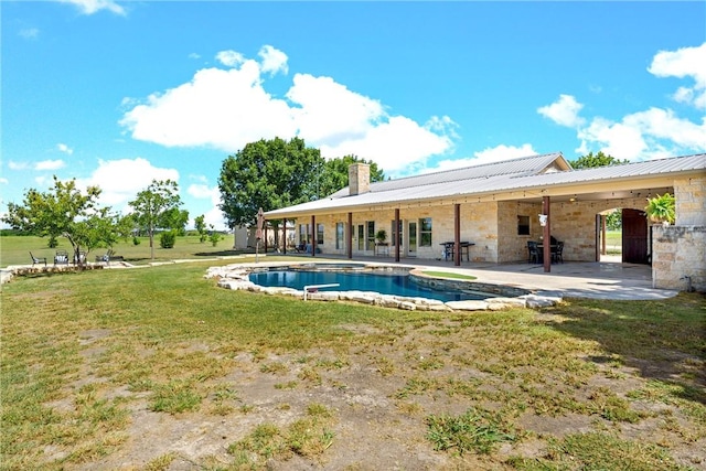 view of swimming pool featuring a lawn and a patio