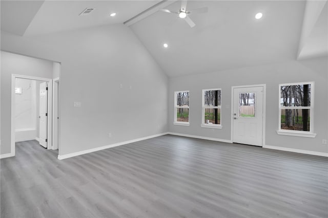 unfurnished living room featuring beamed ceiling, ceiling fan, light hardwood / wood-style floors, and high vaulted ceiling