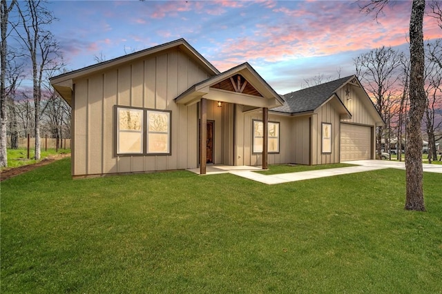 view of front of property with a garage and a yard