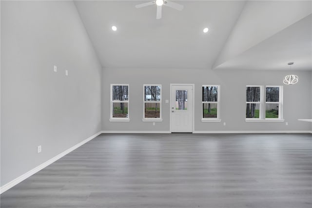 unfurnished living room featuring ceiling fan, high vaulted ceiling, and wood-type flooring