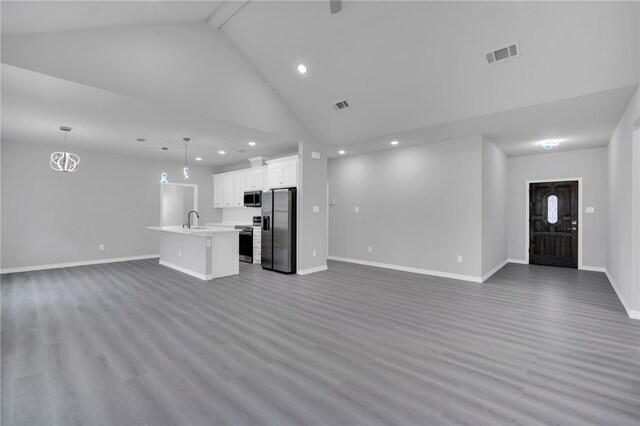 unfurnished living room featuring sink, high vaulted ceiling, dark wood-type flooring, and beamed ceiling