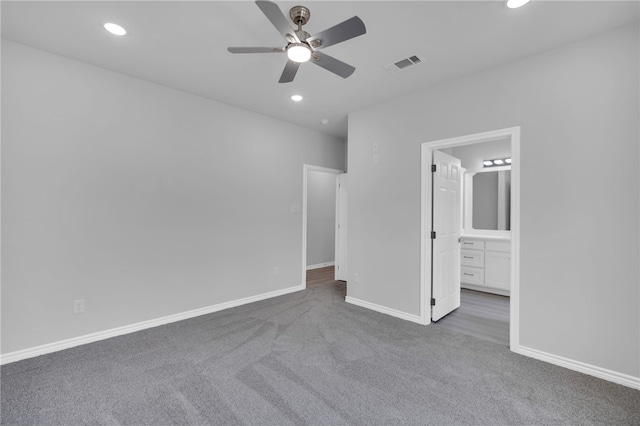 unfurnished bedroom featuring carpet, connected bathroom, and ceiling fan