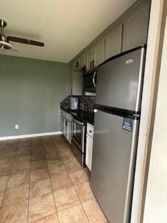 kitchen featuring ceiling fan, light tile patterned floors, and stainless steel appliances