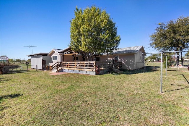 back of property featuring a yard and a deck