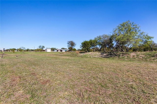 view of yard with a rural view