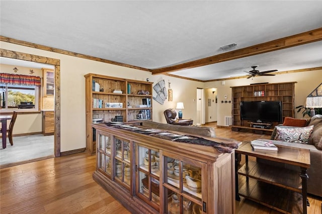 living room with ornamental molding, hardwood / wood-style floors, and ceiling fan