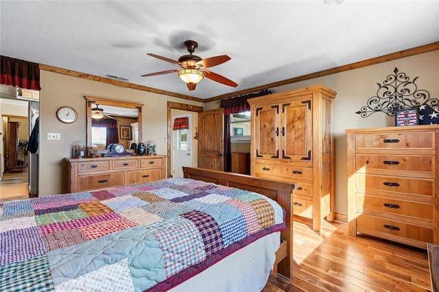 bedroom with ceiling fan, ornamental molding, and light hardwood / wood-style floors