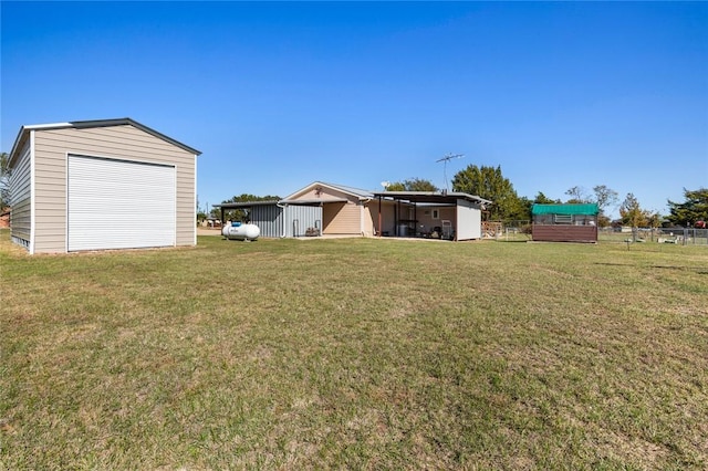 view of yard with a garage and an outdoor structure