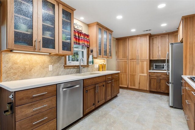 kitchen with sink, backsplash, and appliances with stainless steel finishes