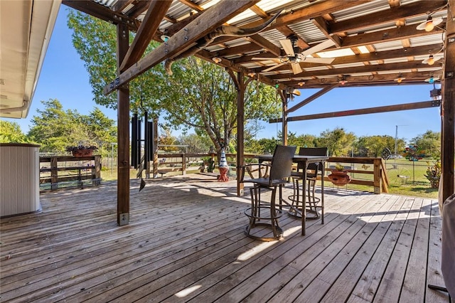 wooden deck with ceiling fan and a pergola