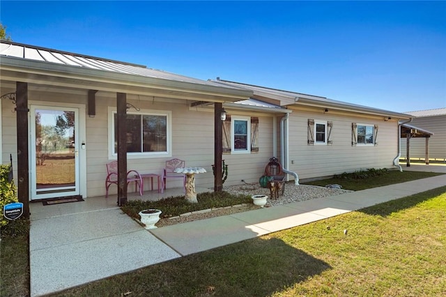 ranch-style house with a front yard and covered porch