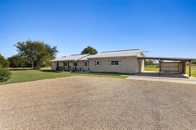 single story home featuring a front lawn and a carport