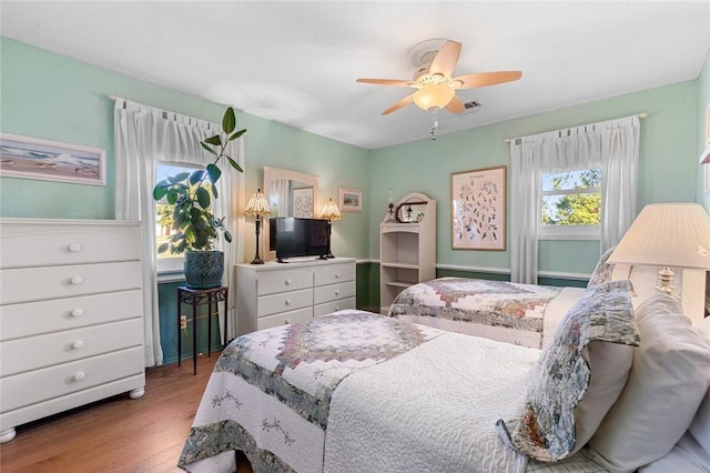 bedroom with ceiling fan and light hardwood / wood-style flooring