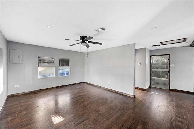 spare room with ceiling fan, electric panel, and dark hardwood / wood-style floors