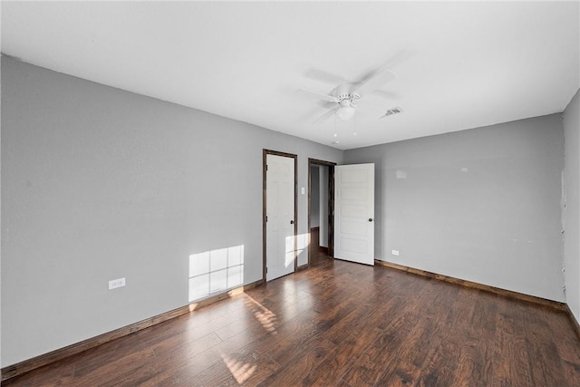 unfurnished bedroom featuring dark wood-type flooring and ceiling fan