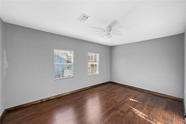 spare room featuring ceiling fan and dark hardwood / wood-style flooring