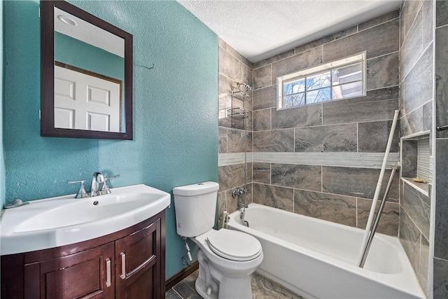 full bathroom with a textured ceiling, toilet, tiled shower / bath combo, and vanity