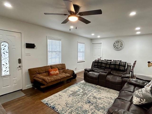 living room featuring ceiling fan and dark hardwood / wood-style flooring