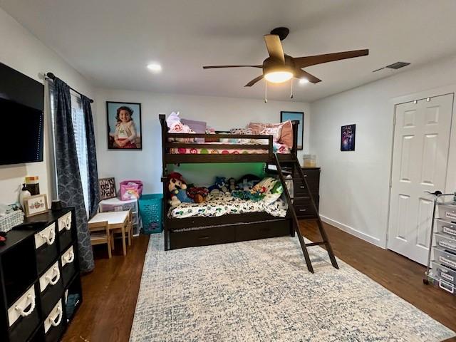 bedroom featuring dark hardwood / wood-style flooring and ceiling fan