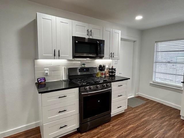 kitchen featuring gas range, decorative backsplash, and white cabinets