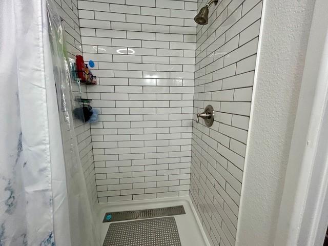 bathroom with a shower with shower curtain