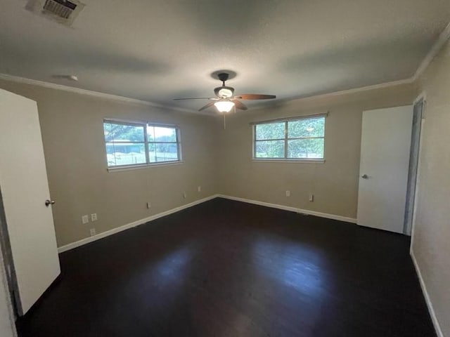 unfurnished bedroom featuring multiple windows, visible vents, and baseboards