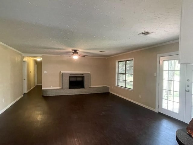 unfurnished living room with visible vents, a fireplace, a textured ceiling, and baseboards