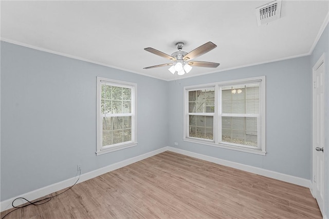 empty room with light hardwood / wood-style floors, ceiling fan, and crown molding