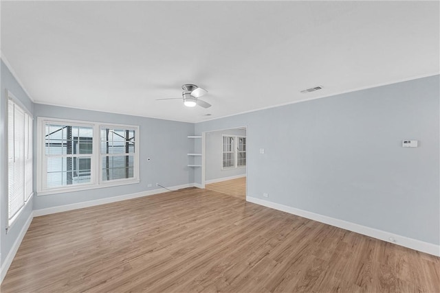 empty room with ceiling fan, light hardwood / wood-style floors, and ornamental molding