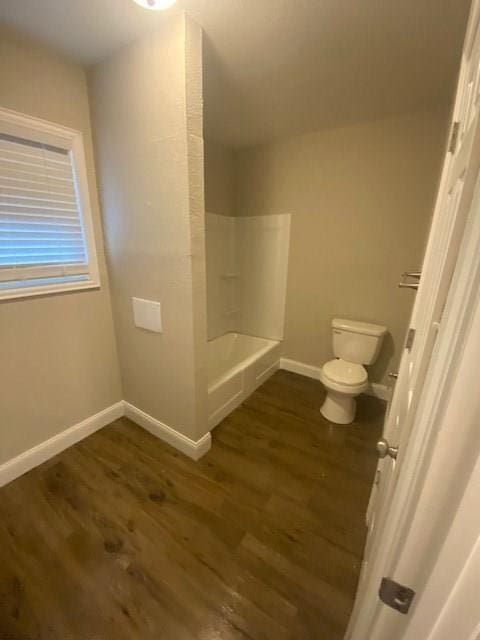 bathroom with wood-type flooring and toilet