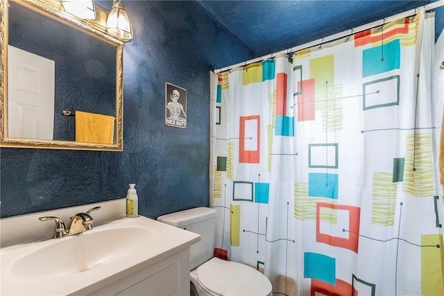 bathroom featuring vanity, toilet, and a shower with shower curtain