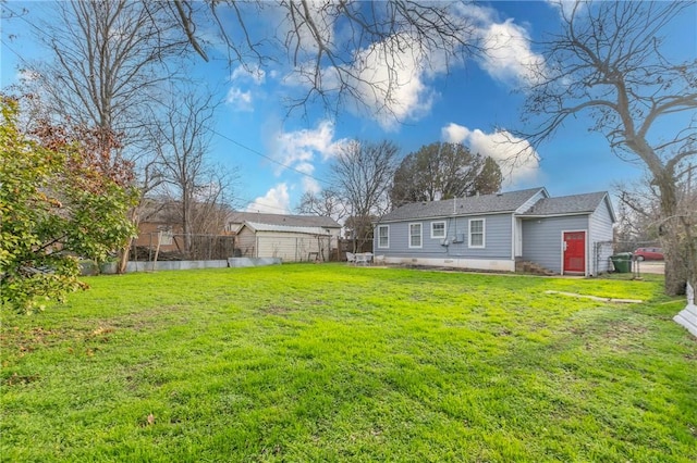 rear view of house with a yard