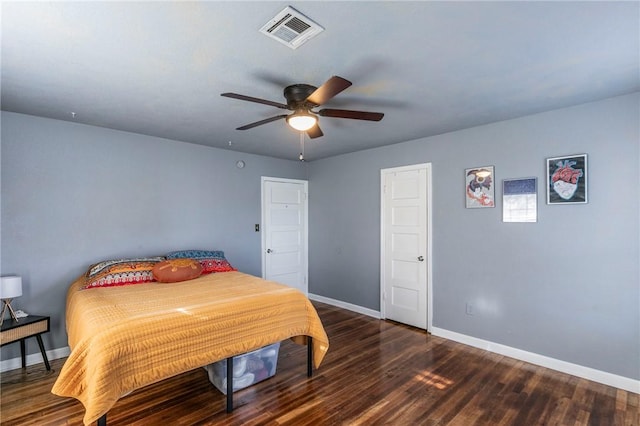 bedroom with dark hardwood / wood-style floors and ceiling fan