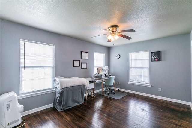 office area featuring a textured ceiling, dark hardwood / wood-style floors, and ceiling fan