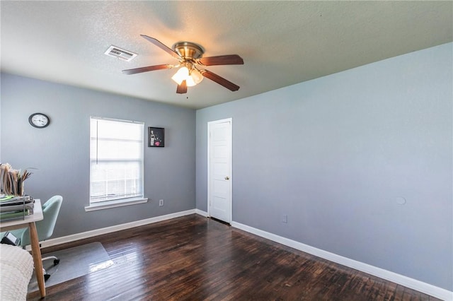 unfurnished office with dark hardwood / wood-style floors, a textured ceiling, and ceiling fan