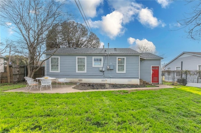 rear view of property featuring a patio area and a lawn