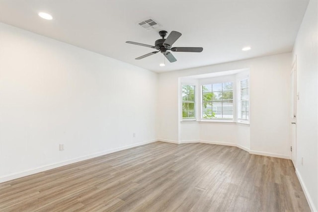 spare room with ceiling fan and light hardwood / wood-style flooring