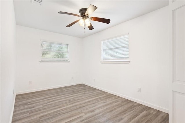 empty room featuring light hardwood / wood-style flooring and ceiling fan