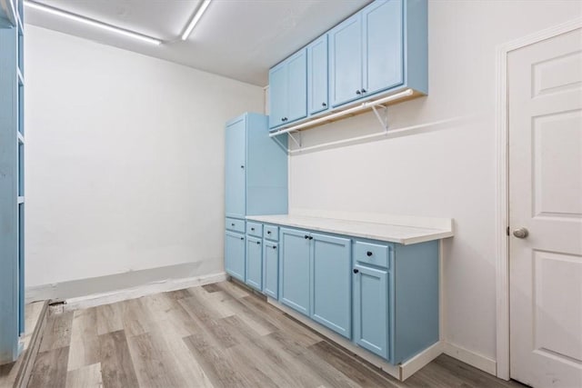 laundry room featuring light hardwood / wood-style flooring