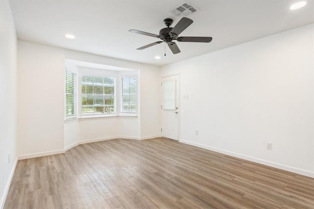 spare room with light hardwood / wood-style floors and ceiling fan