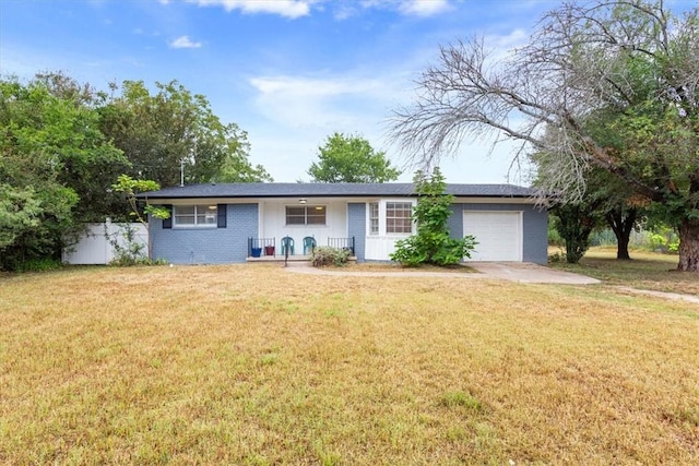 ranch-style house featuring a front yard and a garage