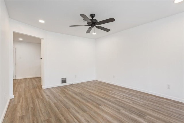 empty room featuring ceiling fan and light hardwood / wood-style floors