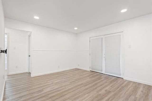 spare room with light wood-type flooring