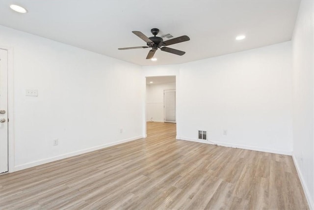 empty room featuring ceiling fan and light hardwood / wood-style flooring