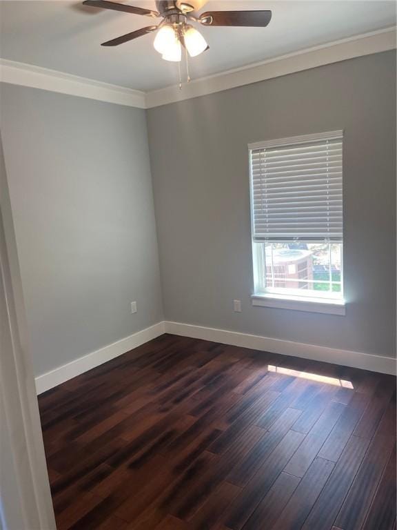 empty room with crown molding, ceiling fan, and dark wood-type flooring