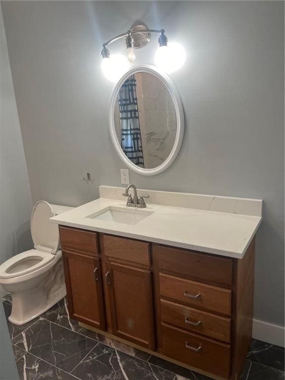 bathroom featuring vanity and toilet