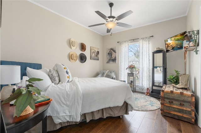 bedroom featuring ornamental molding, wood finished floors, ceiling fan, and access to outside