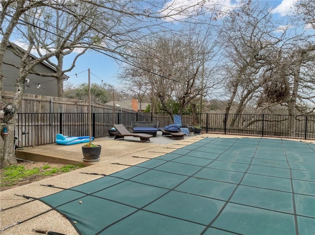 view of swimming pool featuring a patio area, a fenced in pool, and a fenced backyard